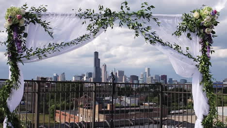 flower archway at wedding venue with chicago skyline in background