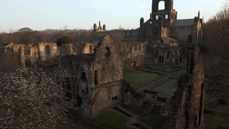 Aerial-Upwards-Pedestal-Shot-of-Kirkstall-Abbey-in-Yorkshire,-England-at-Dawn