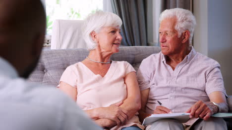 happy senior couple sign a document in a financial meeting