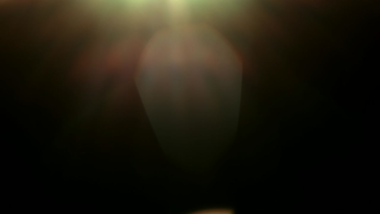 Abstract light leaks on black background.