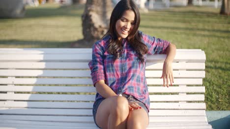 girl relaxing on bench in park
