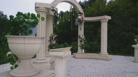 wedding-venue-with-antique-arch-and-columns-near-trees