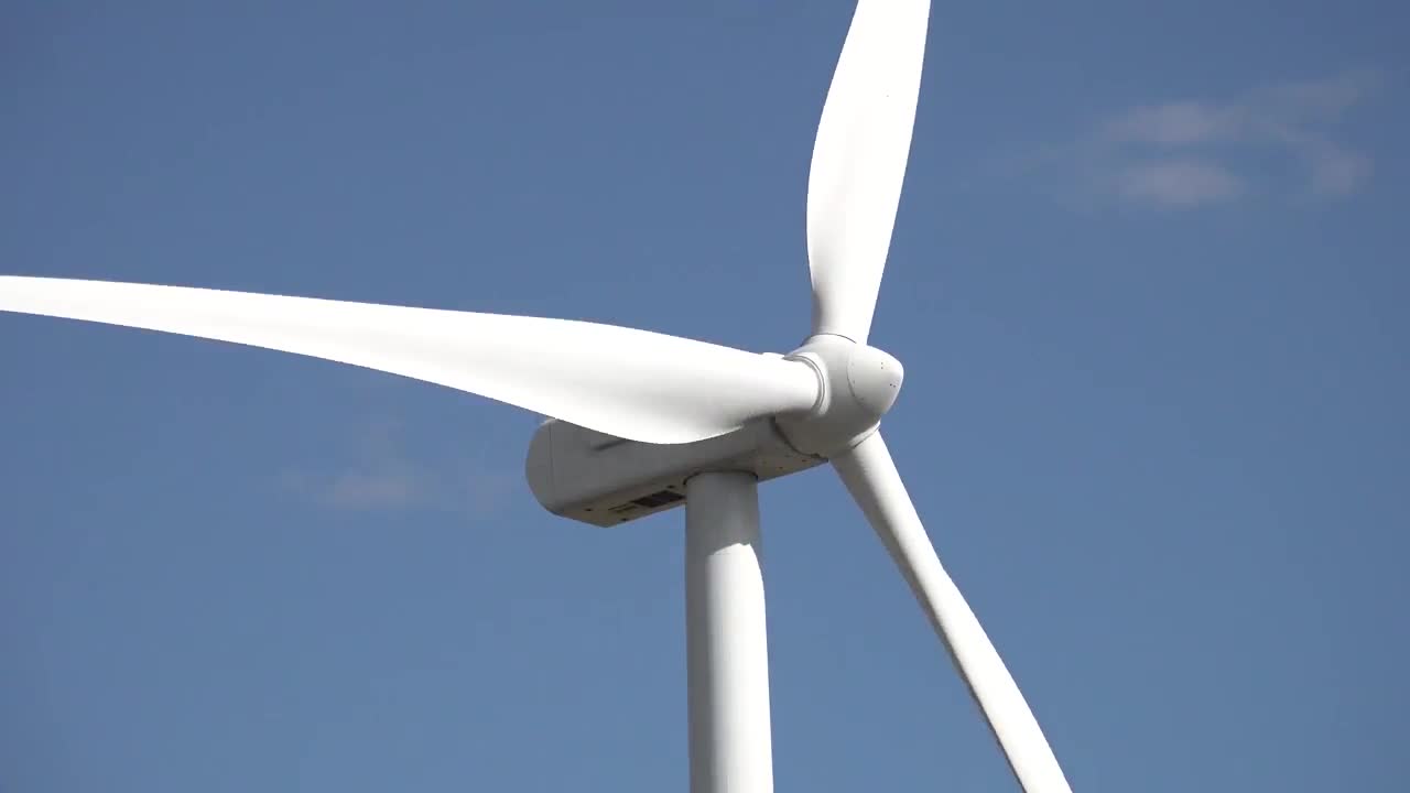 Wind turbines turning in strong winds.