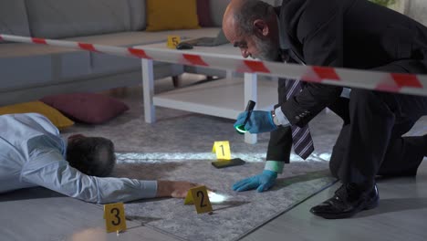 The-detective-man-examines-the-body-at-the-crime-scene-and-tries-to-solve-the-murder.