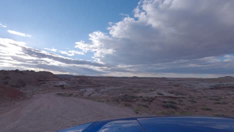 driving along a dirt road in a geologically complex environment - driver point of view