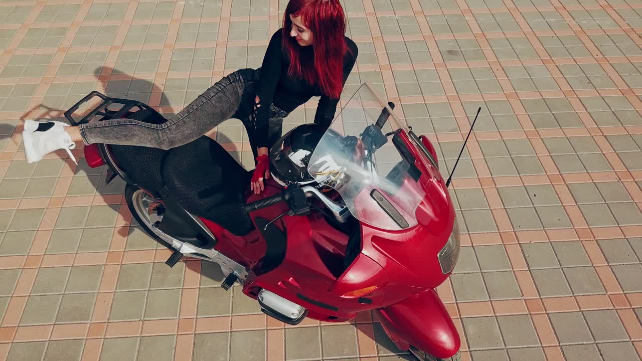 Woman sitting on motorcycle. Top view of woman sitting on modern custom motorcycle