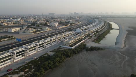 Top-view-of-Ajman-City,-urban-traffic-and-traditional-houses-in-the-United-Arab-Emirates,-4k-Footage