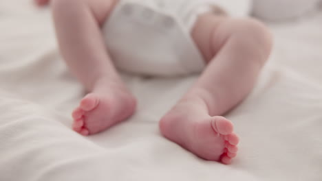 sleeping, adorable and feet of baby on bed