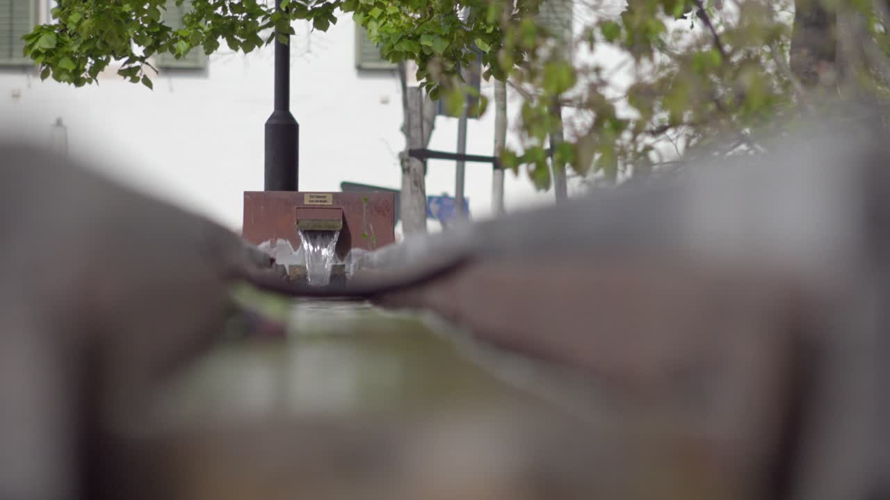 Part of a modernly constructed village fountain in the town of Kurtinig - Cortina, South Tyrol, Italy