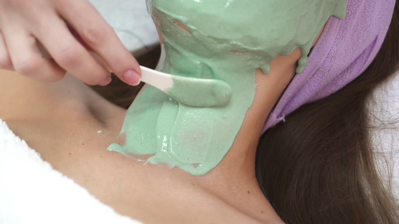 Girl having cosmetic mask. Process cosmetic mask of massage and facials in beauty salon