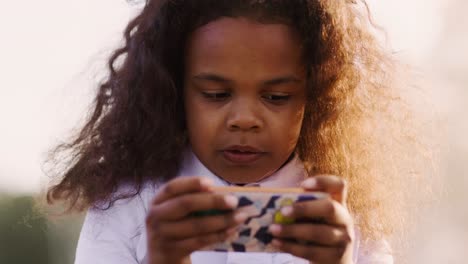 young girl playing on smartphone