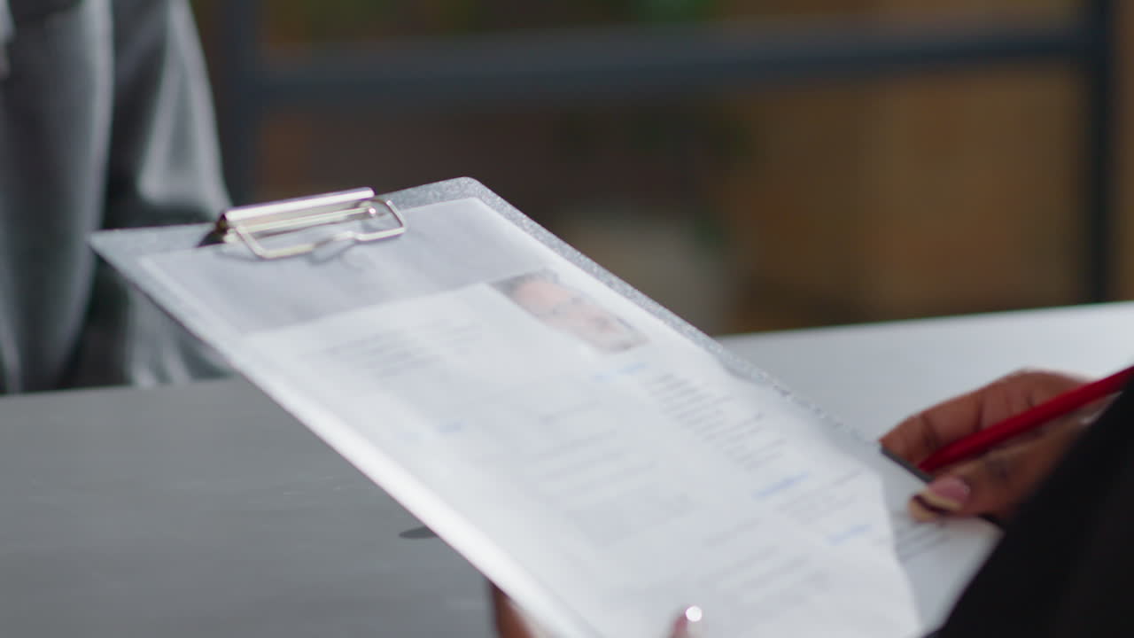 Senior Businessman Giving CV to HR Manager on Job Interview