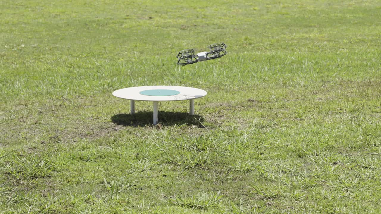 Experience a crucial moment in drone technology as a test flight attempts to land on a designated pad in a sprawling field