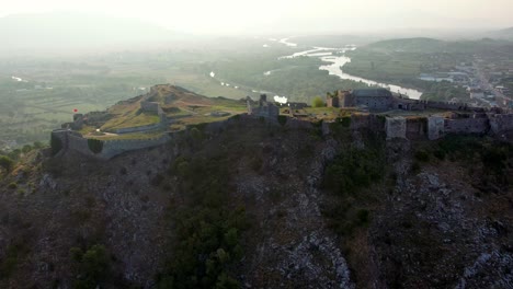 aerial of sunrise at rozafa castle on top of a rock in shkoder albania