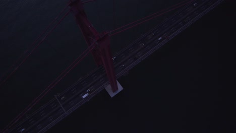 Top-down-shot-of-Ponte-25-de-Abril-bridge-with-light-traffic-in-the-morning,-aerial