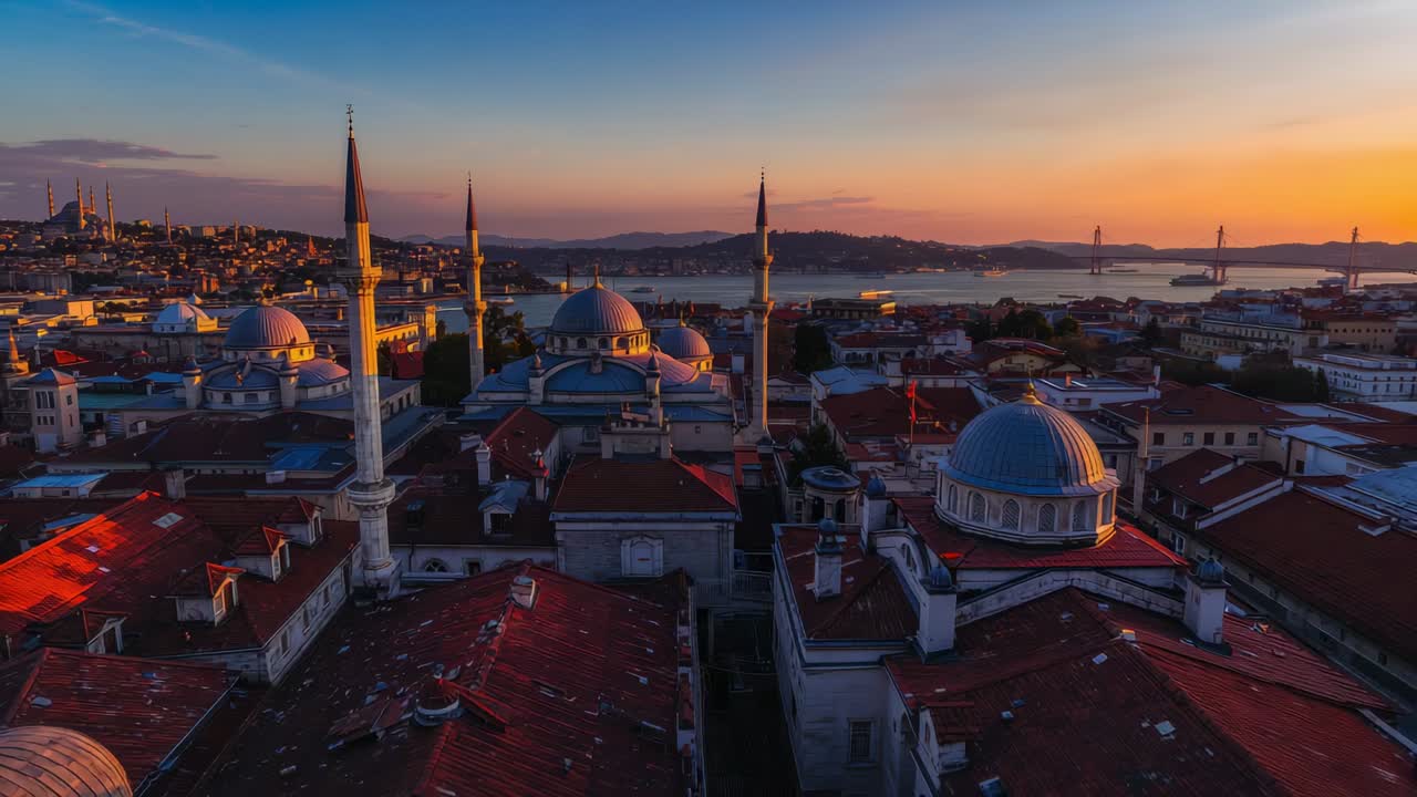 Moving drone revealing domed mosque cluster with minarets at sunset, to show red roofs and bridge