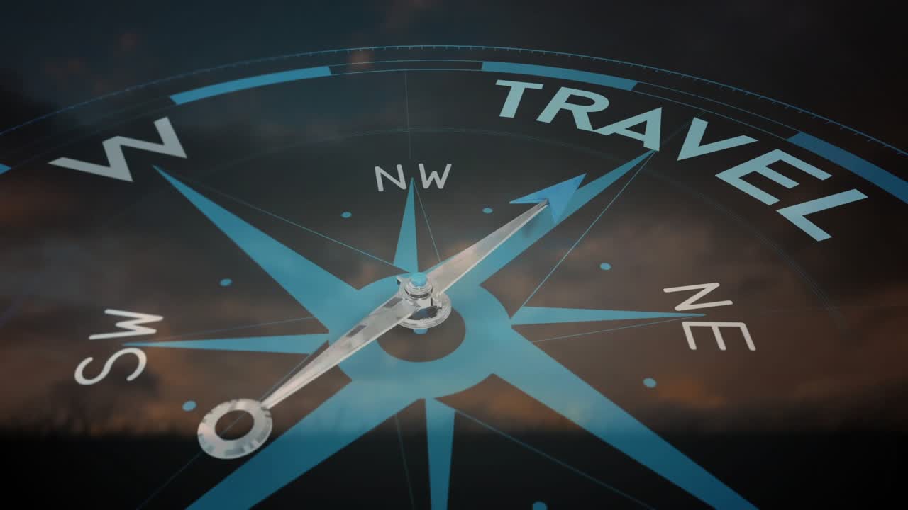 Faint light beam crossing compass face, compass needle rotating clockwise toward TRAVEL rim