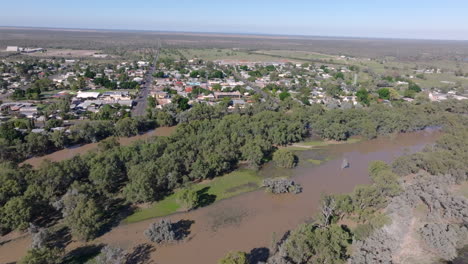 Aerial: Drone tracking slowly around Bourke with the flooded Darling river, NSW, Australia