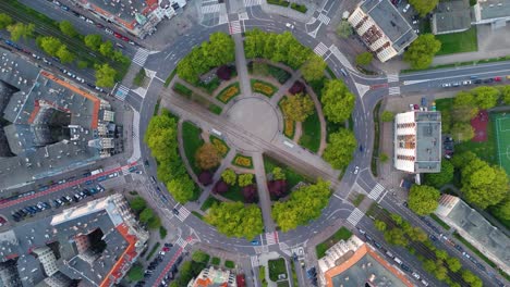 aerial top view of a huge roundabout, full of green trees and plants