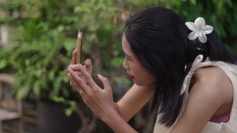 woman taking photo with smartphone