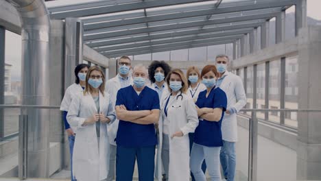 group of doctors with face masks looking at camera, corona virus concept.