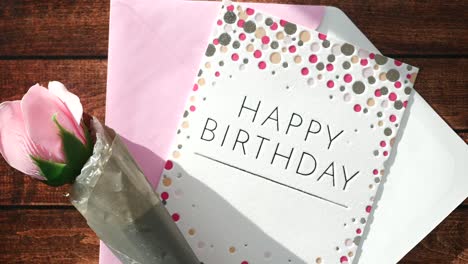 birthday card with pink rose and envelope