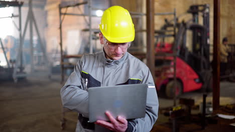 man in hardhat working at the factory