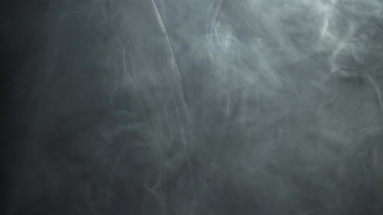 Dense White Smoke Swirling on a Dark Background