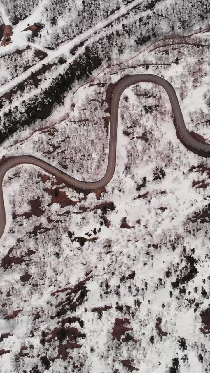 Vertical Aerial fly Mount Zao Stratovolcano, snowy winding Road and Rusty Terrain, Japan