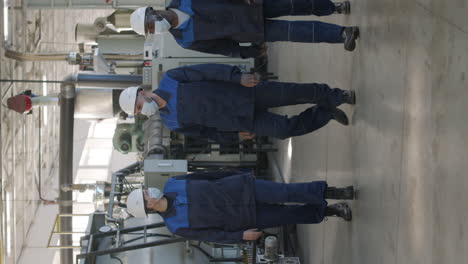 vertical shot of plant workers walking and talking