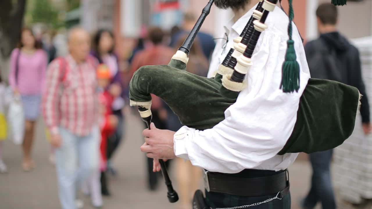 Street Performer Playing His Bagpipes. VINNISA, UKRAINE - MAY 2017: Hands play the bagpipes during the day in the city street