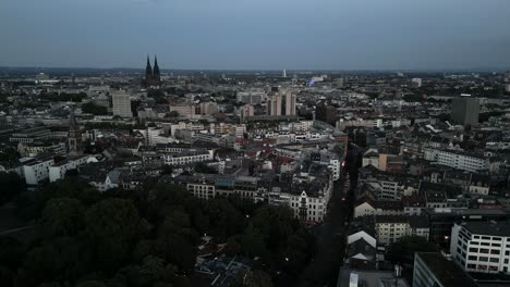 Colonia,-Renania-Del-Norte-westfalia,-Alemania---Vuelo-Aéreo-Descendente-De-Drones-De-Aves-De-La-Silueta-Panorámica-Del-Centro-De-La-Ciudad-De-Köln-Con-Dom-Durante-La-Noche-Del-Amanecer-Vista-Desde-El-Norte-De-Ehrenfeld-En-2022