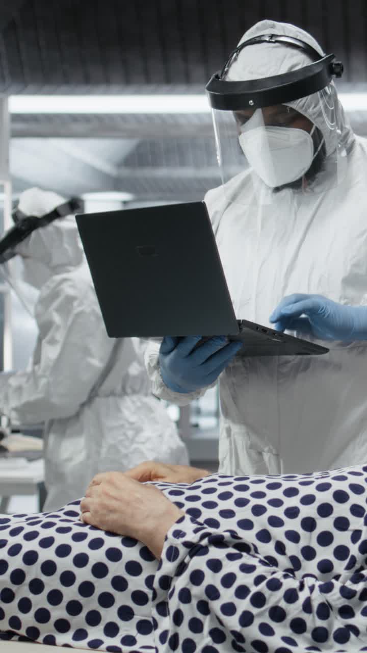 Vertical Video Doctor in biohazard lab conducts medical trial on a contagious patient