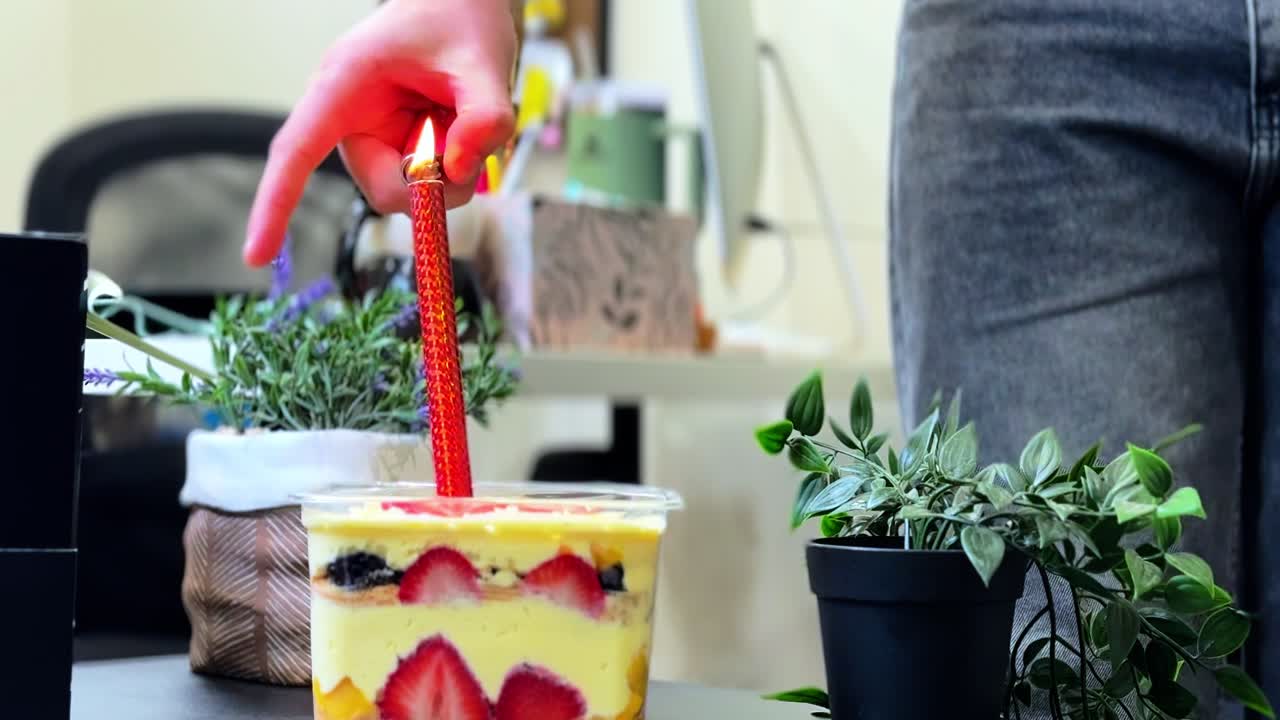 Eye-catching shot of a sparkler candle being lit on a colorful strawberry dessert, perfect for celebrations, birthdays, and festive office events