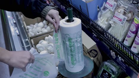 person taking plastic bag for mushrooms