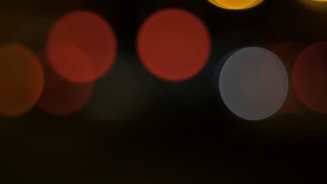 Moving-bokeh-car-traffic-lights-in-city-during-the-night