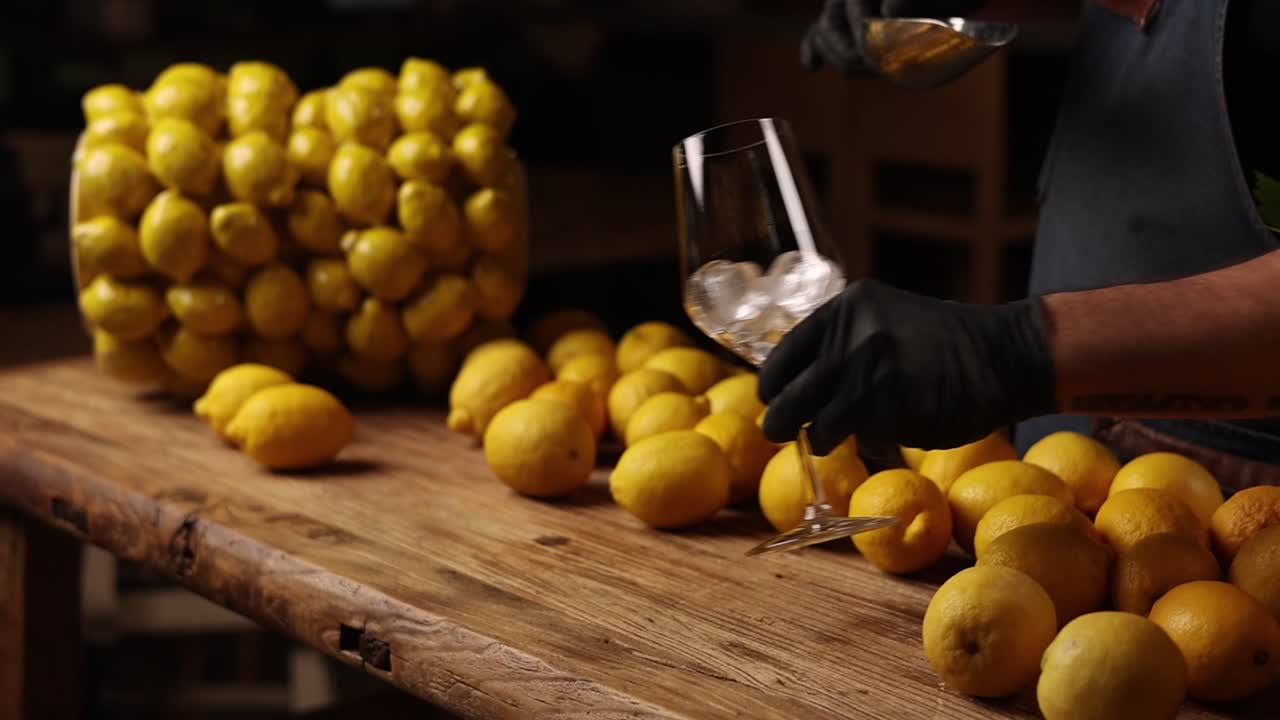 Bartender preparing a cocktail with lemons
