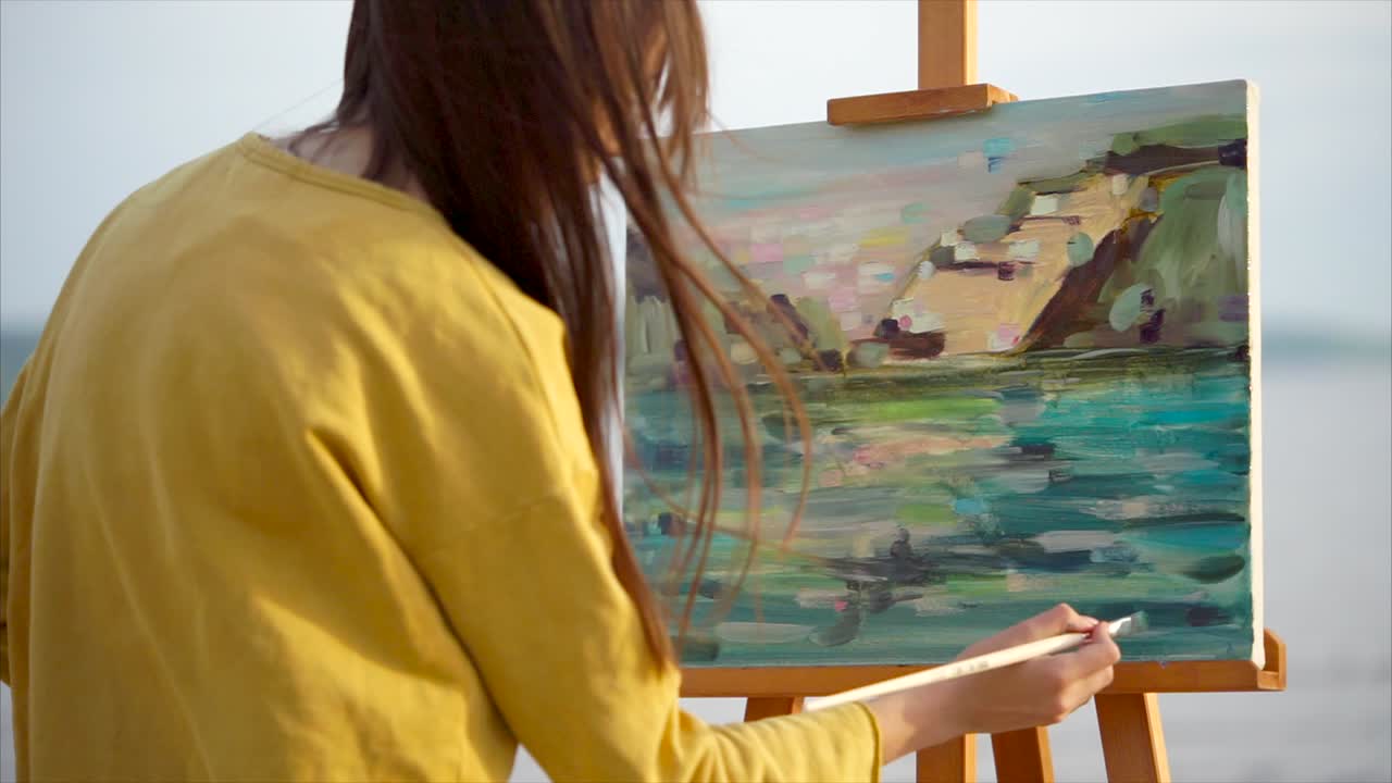 mujer pintando paisajes al aire libre