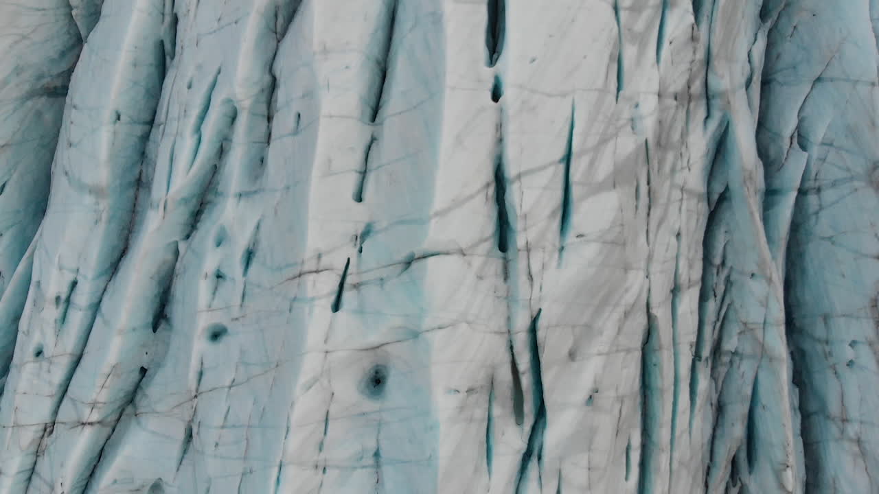 Close Up Aerial View of Glacier Ice in Highlands of Iceland. Scenic Landscape on Cold Winter Day, Tilt Up Drone Shot