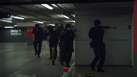 special operation participants storming building. soldiers walking on parking