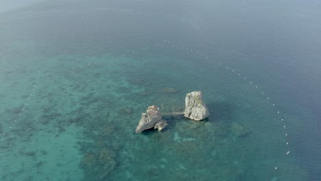 beach resort cabin on a rock formation with seascape at summer near tropical island in the philippines