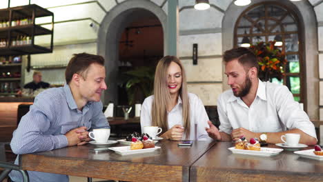 happy colleagues from work socializing in restaurant and eating together