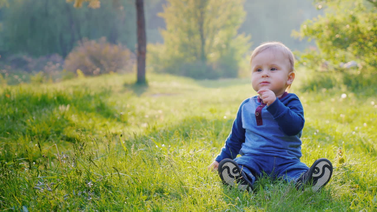 A Little Cool Boy Sits On A Green Meadow 1
