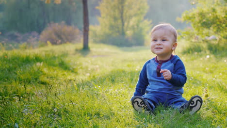 a little cool boy sits on a green meadow 1