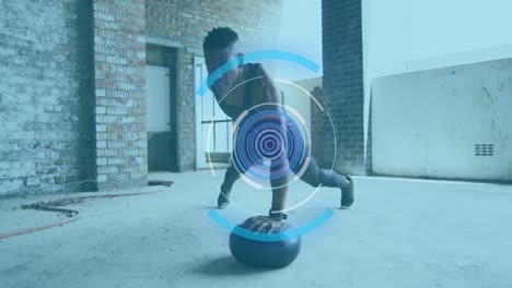 Animation-of-multiple-circles-over-man-exercising-with-ball-in-an-abandoned-building