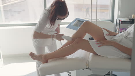 modern technology of permanent hair removal in contemporary cosmetology clinic aesthetician is using laser apparatus