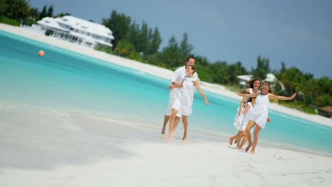 caucasian family together on beach by tropical ocean