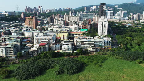 aerial shot of housing buildings surrounded by guandu nature park, taipei