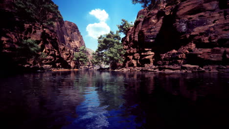 vibrant natural landscape with blue water and rocky cliffs under a clear sky