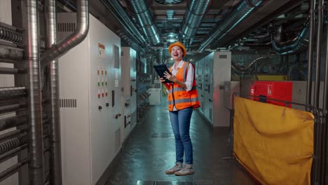 female engineer inspecting machinery in industrial plant